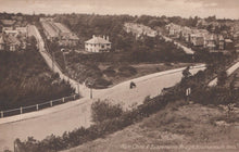 Load image into Gallery viewer, Vintage black and white photograph of a residential area with houses and a road.