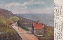 Load image into Gallery viewer, Vintage-style painting of a coastal scene with a small house, path, and sea.