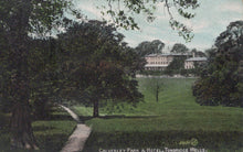 Load image into Gallery viewer, Vintage postcard of Calverley Park & Hotel in Tunbridge Wells with trees and a path.