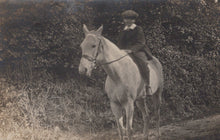 Load image into Gallery viewer, Vintage black and white photo of a child riding a horse in a natural setting