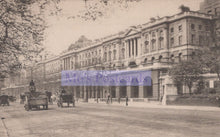 Load image into Gallery viewer, Vintage black and white photo of a city street with horse-drawn carriages and a large building.