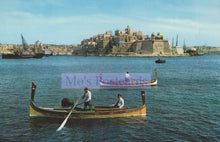 Load image into Gallery viewer, Two gondoliers in a gondola on a body of water with a castle in the background.