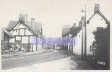 Load image into Gallery viewer, Vintage black and white photograph of a street with houses and a road.