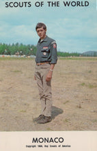 Load image into Gallery viewer, Scout in uniform standing in a field with 'Scouts of the World' and 'Monaco' text on a vintage-style cover.