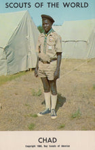 Load image into Gallery viewer, Scout in uniform standing in front of tents with 'Scouts of the World' and 'Chad' text at the top.