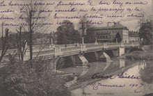 Load image into Gallery viewer, Vintage postcard of a bridge over a river with trees and buildings in the background