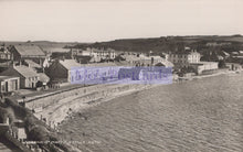 Load image into Gallery viewer, Vintage black and white photo of a coastal town with buildings and a seafront.