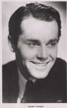 Load image into Gallery viewer, Black and white portrait of a smiling man with text 'HENRY FONDA' at the bottom.