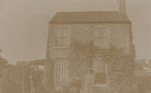 Load image into Gallery viewer, Vintage sepia-toned photograph of a two-story house with people in front