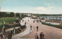 Load image into Gallery viewer, Vintage postcard of Paignton from the Shelter with people walking along a promenade by a body of water.