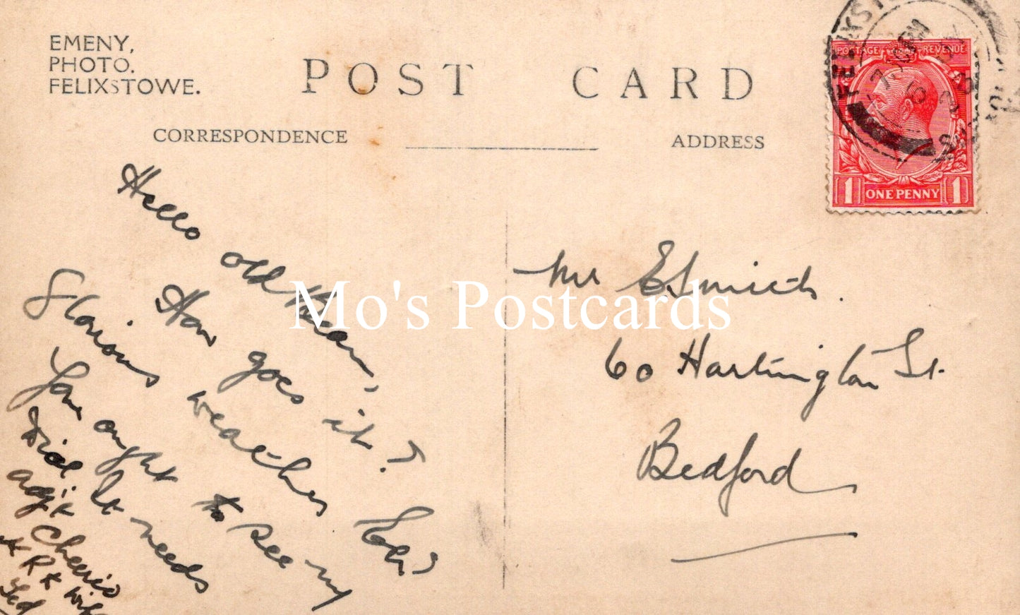Vintage postcard with handwritten text and a red postage stamp