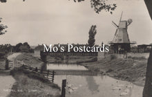 Load image into Gallery viewer, Vintage black and white postcard of a windmill by a canal