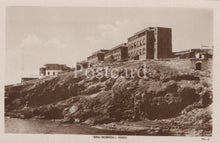Load image into Gallery viewer, Vintage black and white postcard of a coastal scene with buildings on a cliff.