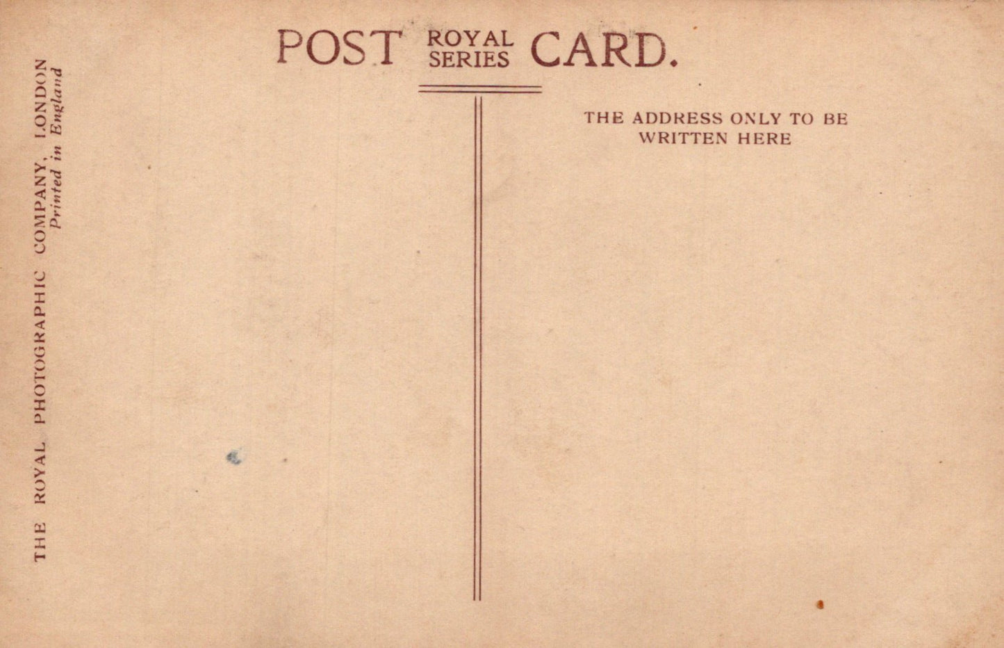 Back of a vintage postcard with text and a vertical line for writing the address.