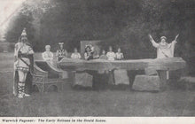 Load image into Gallery viewer, Historical performance scene with people in costumes around a stone circle.