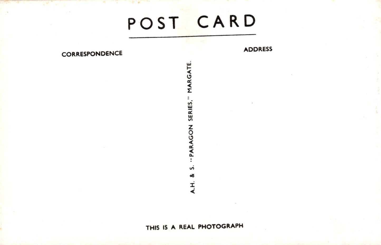 Back of a postcard with text and a signature