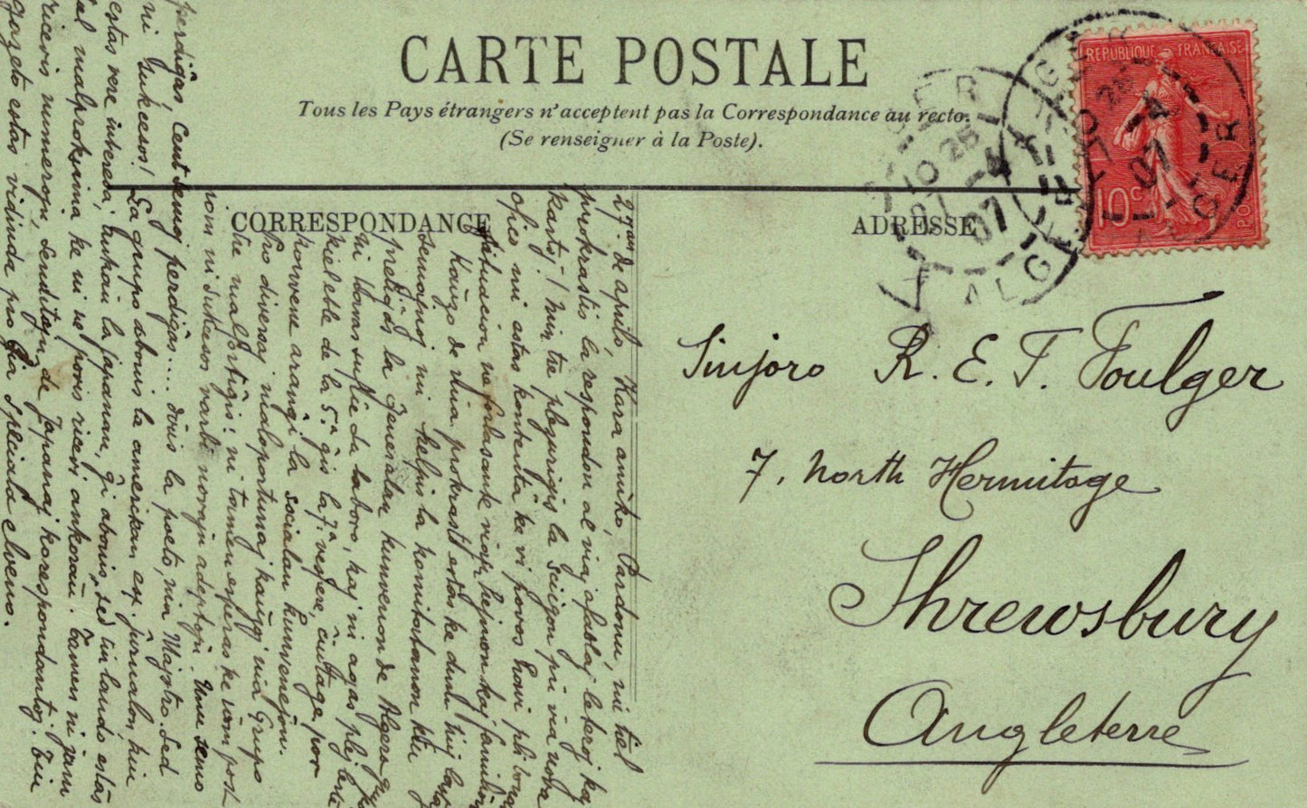 Vintage postcard with text and a red stamp on a green background