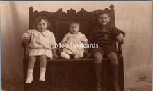 Load image into Gallery viewer, Ancestors Postcard - Three Children Sat on an Ornate Wooden Bench SW16845