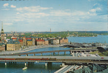 Load image into Gallery viewer, Cityscape with buildings, bridges, and water, featuring a vintage or retro filter.