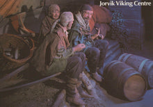 Load image into Gallery viewer, Illustration of three Vikings sitting around a fire with barrels and Viking gear in the background, labeled 'Jorvik Viking Centre'.