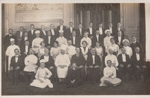 Load image into Gallery viewer, Vintage black and white photograph of a formal group of people in formal wear, likely from an earlier century.