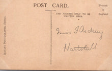 Load image into Gallery viewer, Vintage postcard with handwritten address on a brown background