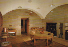 Load image into Gallery viewer, Historic kitchen with stone walls, wooden table, and vintage appliances.