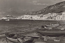 Load image into Gallery viewer, Black and white photograph of a coastal scene with boats and buildings.