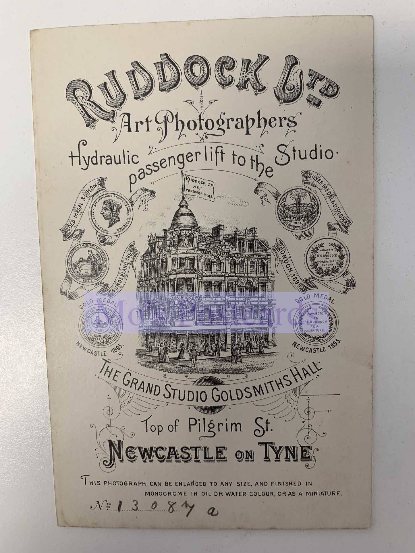 Vintage advertisement for Ruddock & Co. Art Photographers with a building illustration on a white background.