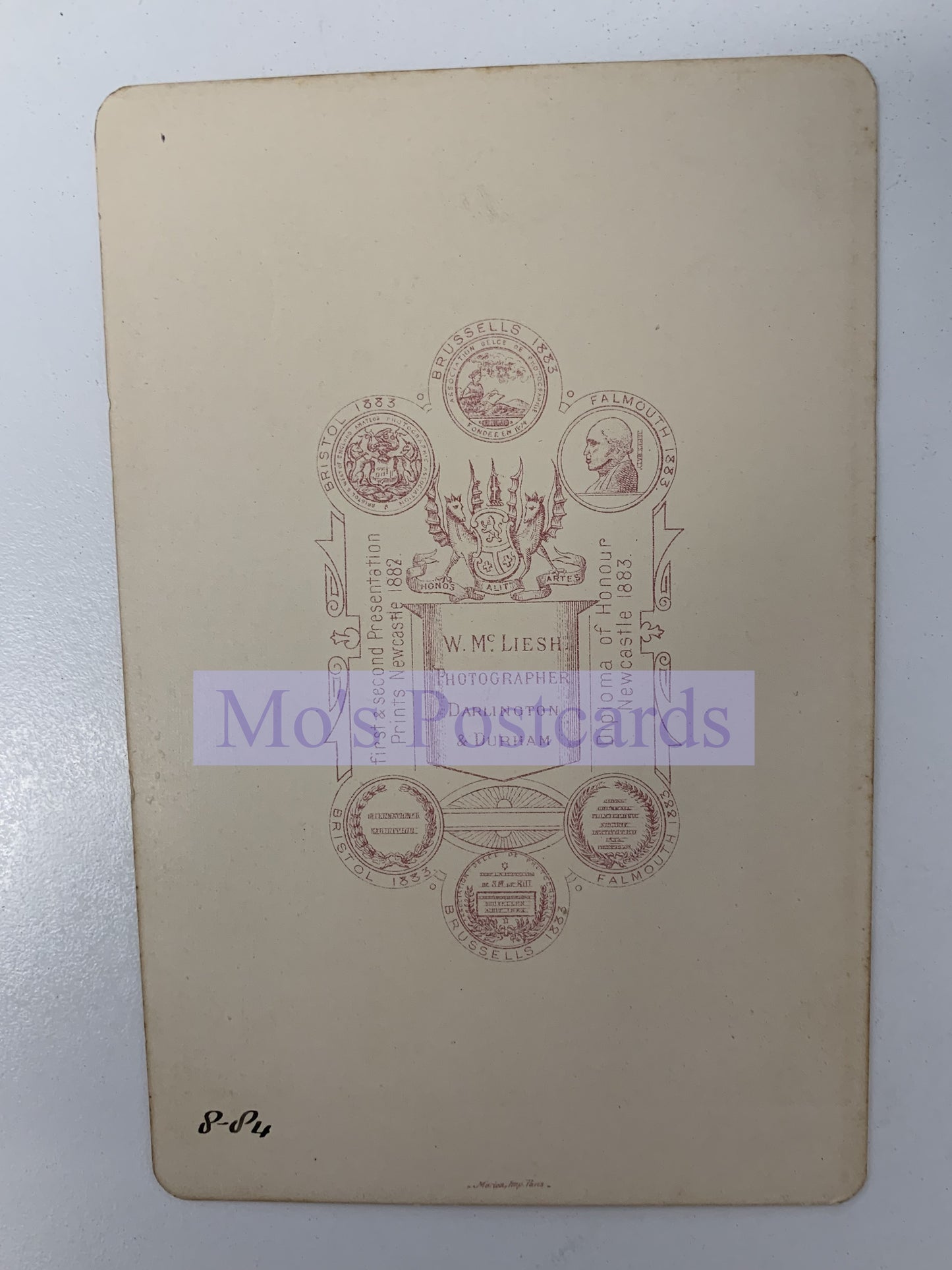 Vintage postcard with intricate designs and text on a beige background