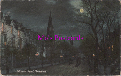 Vintage night scene of a street with buildings and a church spire, labeled 'Mo's Postcards'.