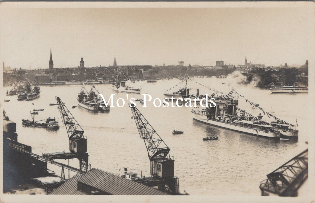 Vintage black and white photo of a harbor with ships and cranes
