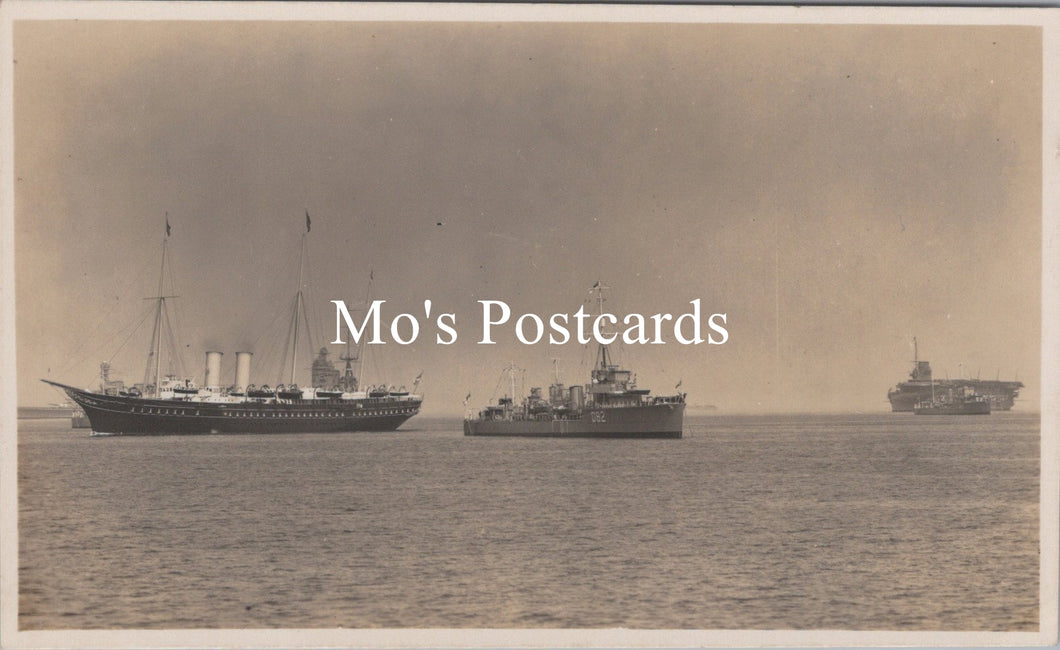 Vintage black and white photograph of ships on water with 'Mo's Postcards' text overlay.