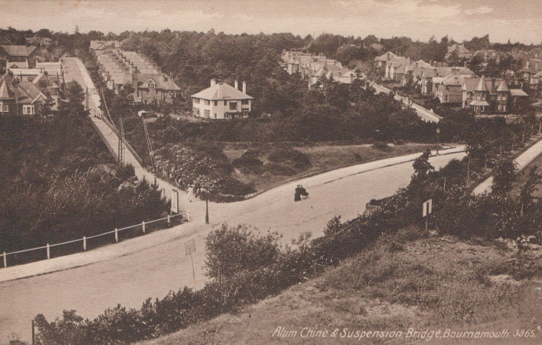 Vintage black and white photograph of a residential area with houses and a road.