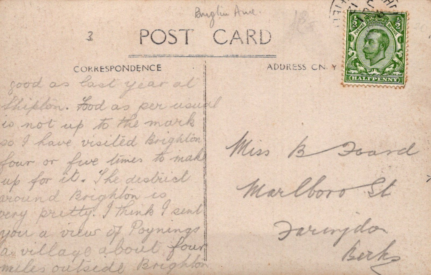 Vintage postcard with handwritten text and a postage stamp on a beige background