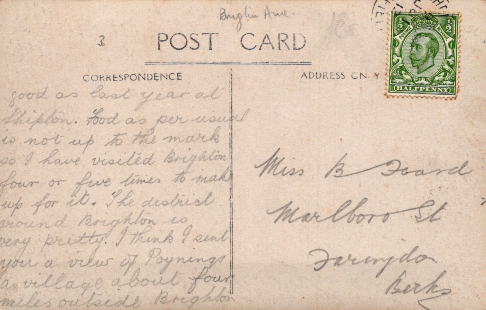 Vintage postcard with handwritten text and a postage stamp on a beige background