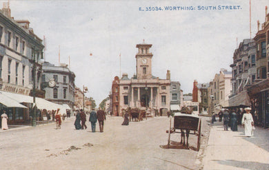 Vintage postcard of South Street in Worthing with a clock tower and people on the street.