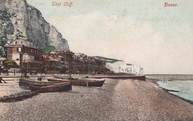 Vintage postcard of East Cliff, Dover with buildings and boats on a pebbly beach.