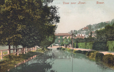 Vintage postcard view of a river with trees and buildings in the background, labeled 'View near River, Dover'.