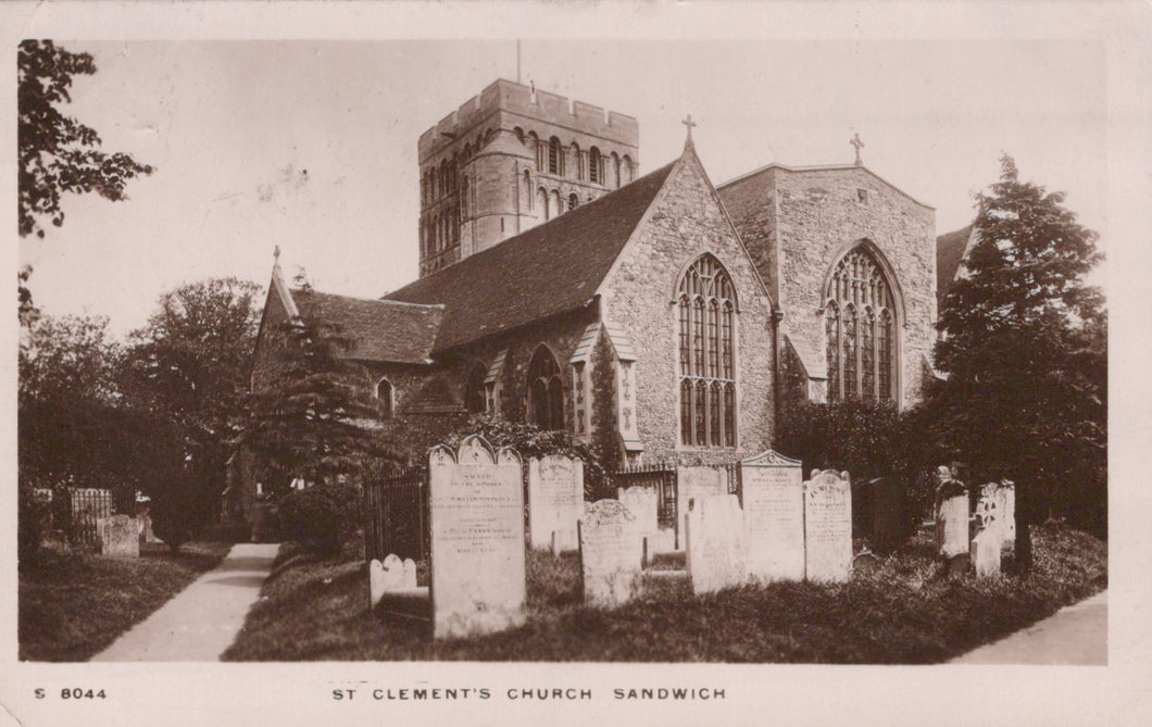 Vintage photograph of St Clement's Church in Sandwich, featuring a stone building with a clock tower and gravestones.