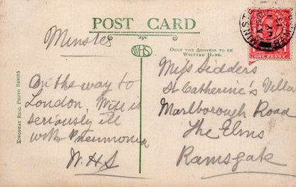Vintage postcard with handwritten text and a red stamp on a beige background