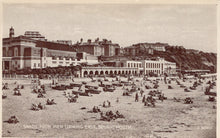 Load image into Gallery viewer, Vintage black and white photo of a beach scene with buildings and people from a pier in Bournemouth.

