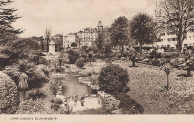 Vintage black and white photograph of Upper Gardens in Bournemouth with buildings in the background.