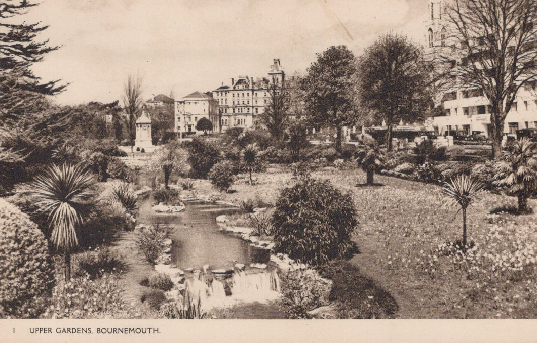 Vintage black and white photograph of Upper Gardens in Bournemouth with buildings in the background.