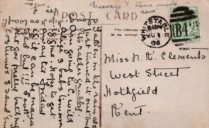 Vintage postcard with handwritten text and stamps, featuring a scenic view.