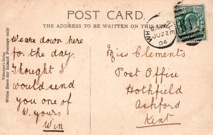 Vintage postcard with handwritten text and a stamp, featuring a beige background.