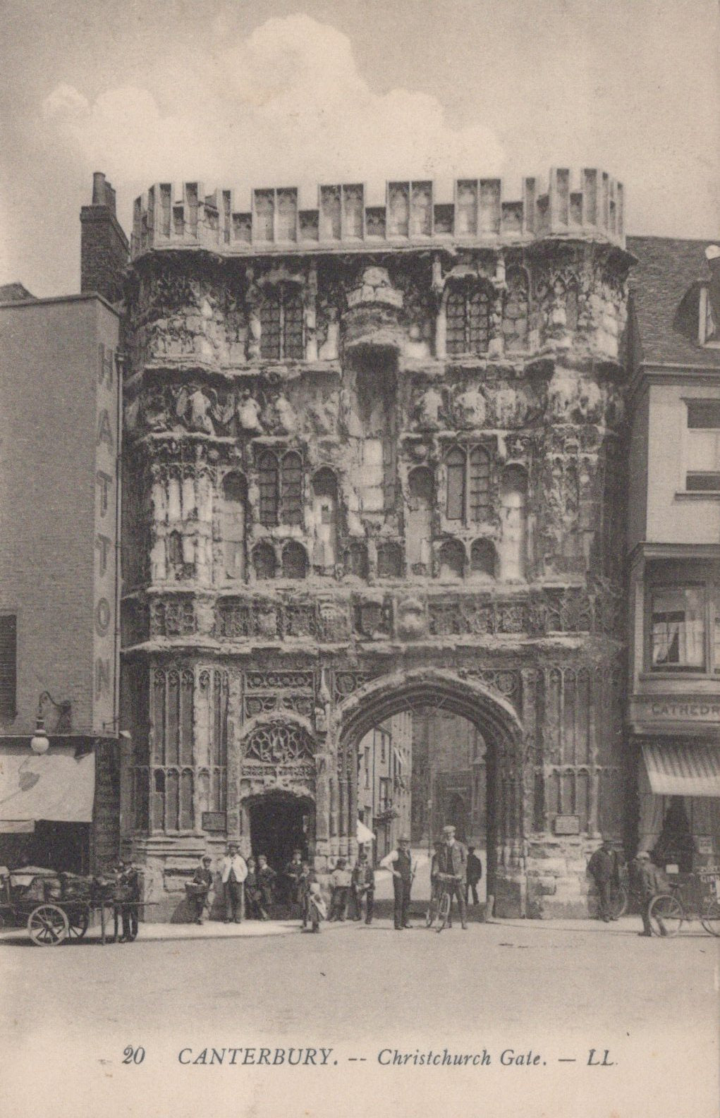 Vintage photograph of Christchurch Gate in Canterbury, featuring a large stone gatehouse with people gathered around.
