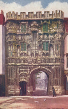 Load image into Gallery viewer, Historic stone gate with decorative elements in a cityscape
