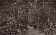 Load image into Gallery viewer, Vintage black and white photograph of a person sitting on a bench in a forested area with &#39;Pine Walk, Folkestone&#39; text.
