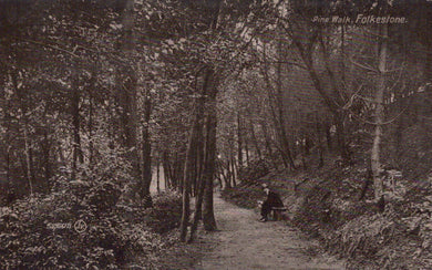 Vintage black and white photograph of a person sitting on a bench in a forested area with 'Pine Walk, Folkestone' text.